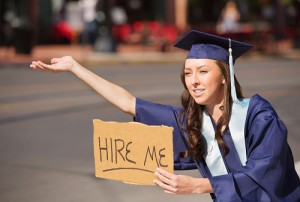 Graduate with Hire Me Sign