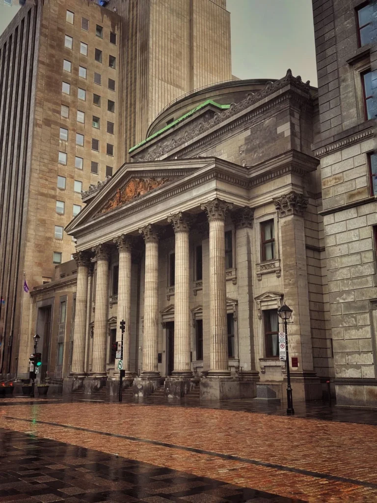 Architectural view of the iconic Bank of Montreal building in downtown Montreal, showcasing classic design and cityscape.